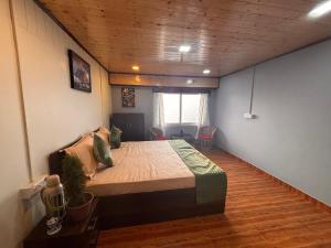 a bedroom with a large bed in a room at Tholangi Homes in Darjeeling