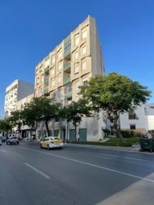 a yellow car driving down a street in front of a building at My home in Tétouan