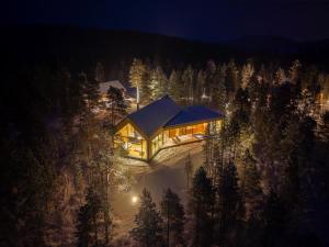 a house on the side of a mountain at night at Inai Haven in Ivalo +15 photos