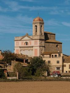 a large building with a tower on top of it at La Caseta del Ter in San Juan de Mollet