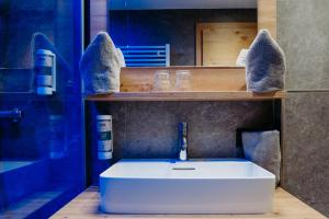 a bathroom with a white sink and a mirror at B&B Gästehaus Alpenblick in Lermoos +53 photos