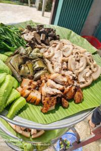 a plate of food with mushrooms and vegetables on at Y Sao Homestay in Hòa Bình +108 photos