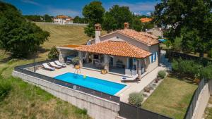 an aerial view of a house with a swimming pool at Villa Melnica by Villas Guide in Barban