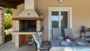 a patio with a table and an outdoor oven at Villa Melnica by Villas Guide in Barban