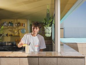 a man standing at a counter with a drink at Hotel Aria in Rimini +154 photos