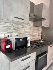 a kitchen with a toaster and a microwave on a counter at GioNi HOUSE in Collegno