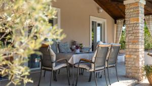 a dining table and chairs on a patio at Villa Melnica by Villas Guide in Barban