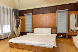 a bedroom with a large bed with a wooden headboard at Olive Villa in Khu Chi Lăng