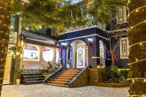 a building with stairs in front of a building at Olive Villa in Khu Chi Lăng