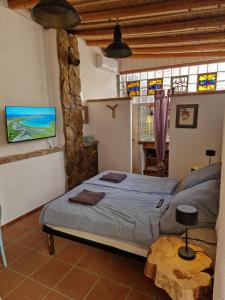 a bedroom with a bed and a tv on the wall at Casa Olive in San Vito +24 photos