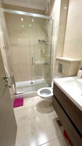a bathroom with a shower and a toilet and a sink at Safari lodge in Udawalawe