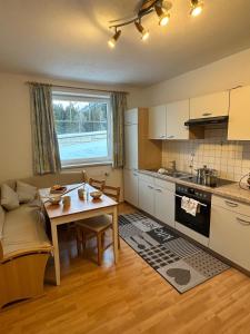 a kitchen with a table and a dining room at LechBrugger Berg Appartements in Holzgau