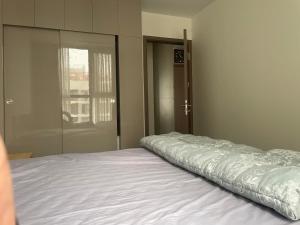 a white bed in a room with a window at Dulichxanh3026 in Gia Lâm Pho