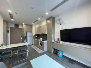 a large kitchen with a large flat screen tv at Dulichxanh3026 in Gia Lâm Pho