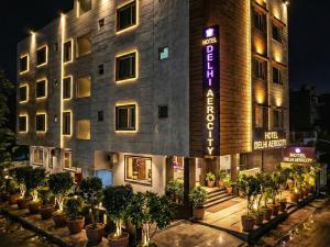 a building with potted plants in front of it at Hotel Delhi Aerocity in New Delhi