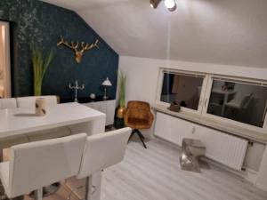 a living room with white furniture and a window at Appartement am Diemelsee Infrarotsauna inklusive in Marsberg