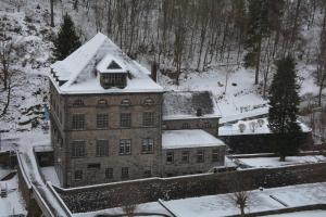 a large brick building with snow on top of it at Appartement am Diemelsee Infrarotsauna inklusive in Marsberg