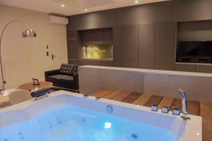 a large bath tub in the middle of a room at My Spa in Reims