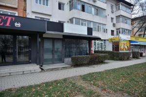 a store on a street in front of a building at Glow Sahara in Focşani