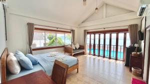 a bedroom with a bed and a view of a pool at Bangsaphan Resort in Bang Saphan