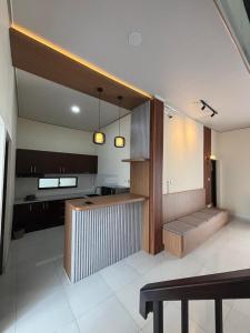 a kitchen with a table and a bench in a room at Heiwana House #1 in Beran-kidul