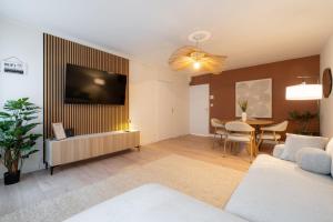 a living room with a television and a table at Harmony in Arras