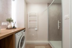 a bathroom with a washing machine and a shower at Harmony in Arras