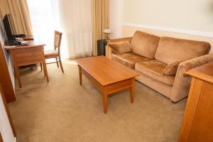 a living room with a couch and a table at Hotel Dominika in Bratislava