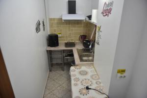 a small kitchen with a sink and a refrigerator at Glow Sahara in Focşani