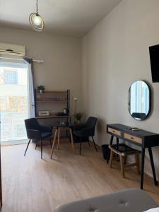 a living room with a desk and a mirror at BYZANTIUM APARTMENTS in Ermoupoli