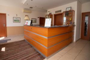 a bar in a restaurant with a counter at Hotel Dominika in Bratislava