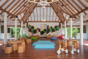 a large room with wooden ceilings and wooden tables at Heritance Aarah - Premium All Inclusive - 40 Minutes away from Male by Seaplane in Raa Atoll +175 photos