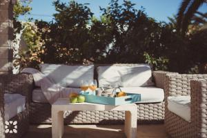 a table with a tray of fruit on a wicker couch at Villa Ananas by Abahana Villas in Moraira