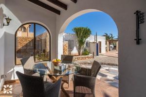 a dining room with a glass table and chairs at Villa Ananas by Abahana Villas in Moraira