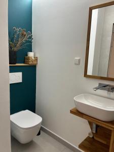 a bathroom with a white toilet and a sink at In the nature in Vroutek