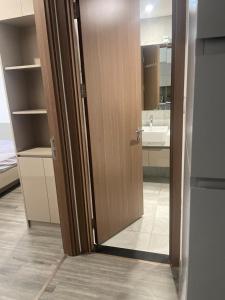 an open door to a bathroom with a sink at Dulichxanh3026 in Gia Lâm Pho +1 photo