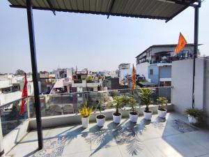 a row of potted plants sitting on a balcony at Hotel Gurukripa in Ujjain