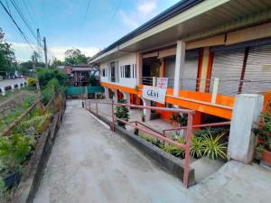 a house with an orange railing next to a building at Aunora Standard Room in San Miguel