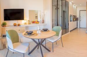 a dining room with a table and chairs at Palmera - Spacious Studio with Pool View in Vasilia