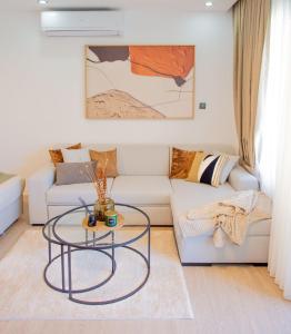 a living room with a couch and a glass table at Palmera - Spacious Studio with Pool View in Vasilia