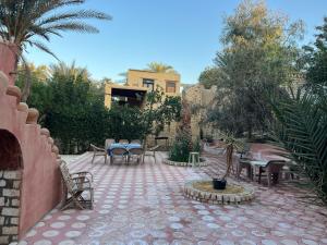 a patio with tables and chairs in a courtyard at Tunis Village Chalet in Fayoum
