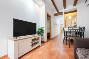 a living room with a flat screen tv on a entertainment center at Portal del Carro 7 Junto a la Catedral in Tarragona