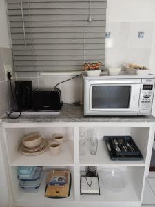 a kitchen with a microwave on a counter top at Cozy Cove in Cape Town