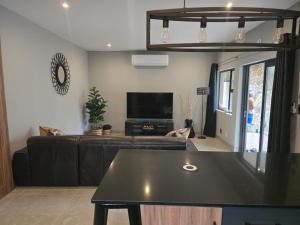 a living room with a couch and a table at Cranes Nest Guest House in Pretoria