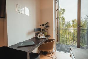 a desk in a room with a large window at Mod 05 Bike Hotel in Castelnuovo del Garda