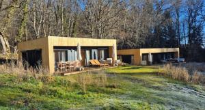 a house in the middle of a field at Les Ecolodges du Lac in Chambon-sur-Lac