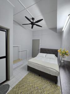 a bedroom with a bed and a ceiling fan at TWS Homestay in Batu Caves