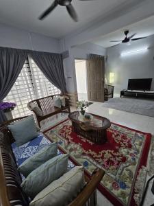 a living room with a couch and a coffee table at TWS Homestay in Batu Caves