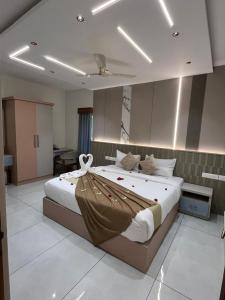 a bedroom with a large bed with a flower on it at Bumblebee Pool Villa Munnar in Anachal