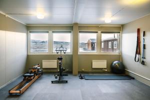 a gym with two tread machines and two windows at The Highland Center Hrauneyjar in Sprengisandur